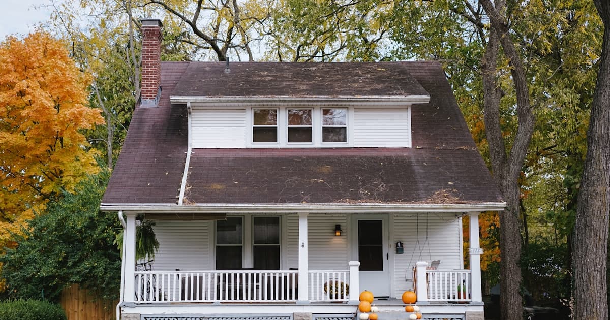 Minnesota suburban home in warm sunlight with protection shield concept for homeowners insurance